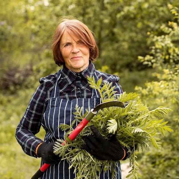 Elderly woman happily gardening, looking vibrant and focused.