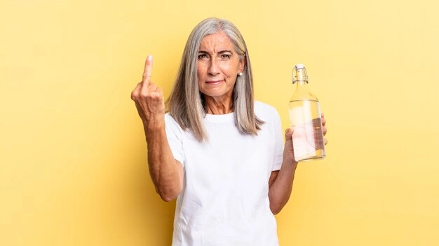 Elderly woman with Rhodiola bottle, smiling, looking stress-free and energetic.